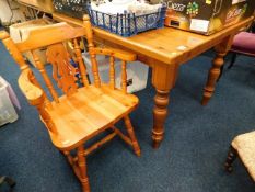 A chunky pine dining table twinned with a pine cha