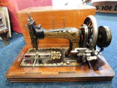 A Frister & Rossmann sewing machine with box and k