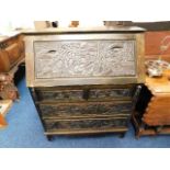Stained pine bureau with carved Chinese figures