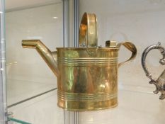 A large brass watering can