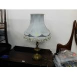 Decorative brass table lamp with fringed shade