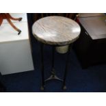 A marble topped pedestal table with brass claw fee