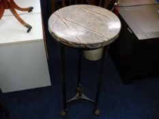 A marble topped pedestal table with brass claw fee