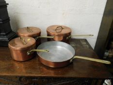 Three copper pans and copper frying pan with brass