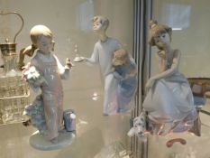 Three Lladro figures ; girl with phone handset loo