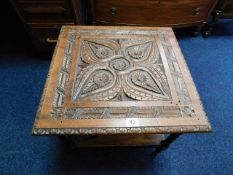 A low level table with carved oak top