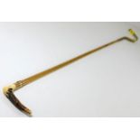 A 19thC. riding crop with yellow metal fittings on