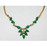 An 18ct gold necklace set with emeralds & diamonds