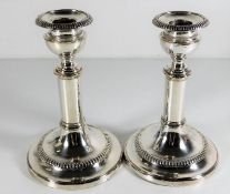 A pair of silver plate on copper candlesticks 6.75