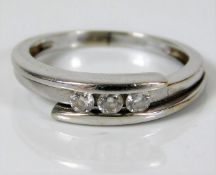 An 18ct white gold ring set with three diamonds 2.