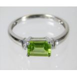 A 9ct white gold ring set with peridot & diamonds