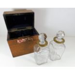 An oak cased decanter set with brass collars, box