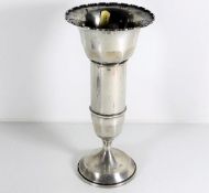 A silver footed vase with scalloped rim by Charles