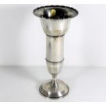 A silver footed vase with scalloped rim by Charles