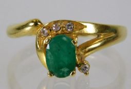 An 18ct gold ring set with emerald & diamond ring