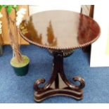 A 19thC. mahogany pedestal table with pie crust st