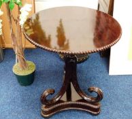 A 19thC. mahogany pedestal table with pie crust st