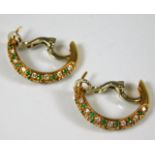 A pair of 18ct gold earrings set with emerald & di