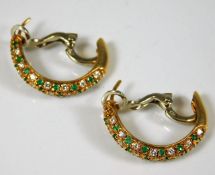 A pair of 18ct gold earrings set with emerald & di