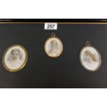 A mounted triptych of miniature watercolours featu