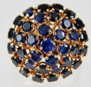 A 1950's yellow metal cocktail ring, tests as 18ct gold, set with sapphires size P