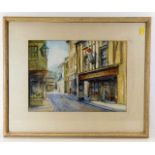 A framed watercolour of antiques shop in Looe, ima
