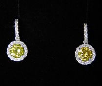 A pair of 18ct white gold earrings set with white