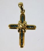 A 9ct gold cross set with blue diamonds 1g