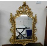 An ornate reproduction gilt framed mirror 50in wid