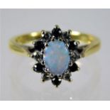 An 18ct gold ring set with opal, diamond & sapphir