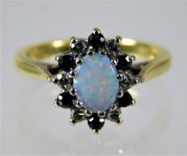 An 18ct gold ring set with opal, diamond & sapphir