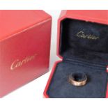 A Cartier rose gold love ring set with three diamo