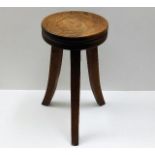 A stylised low level oak stool with flared legs 19