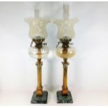 A pair of large oil lamps set with brass corinthia