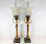 A pair of large oil lamps set with brass corinthia