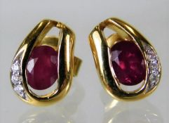A pair of 18ct gold earrings set with ruby & earri