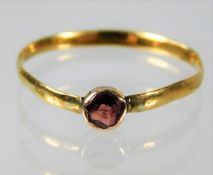 A 22ct gold band set with garnet a/f size N