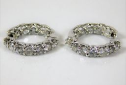 A pair of 14ct white gold earrings set with approx