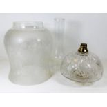 An antique cut glass oil lamp well, an etched oil