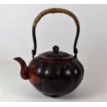 A Japanese bronze teapot with chased decor 8.25in