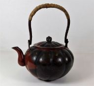 A Japanese bronze teapot with chased decor 8.25in