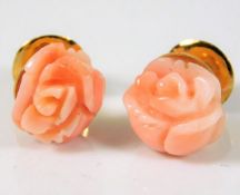A pair of yellow metal mounted carved coral earrin