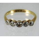 An 18ct gold ring set with five diamonds of approx