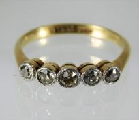 An 18ct gold ring set with five diamonds of approx