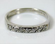 A 9ct white gold ring set with 0.15ct diamonds 2.2