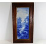 A 19thC. blue & white porcelain plaque depicting Medmenham set in oak frame 18.75in wide x 15.625in