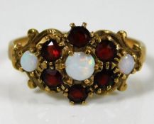 A 9ct gold ring set with garnet & opal 2.1g size L