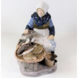 A porcelain figure of woman fishmonger by B&G Cope