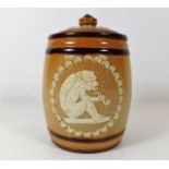 A Doulton stoneware tobacco jar with ape style fig