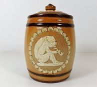 A Doulton stoneware tobacco jar with ape style fig